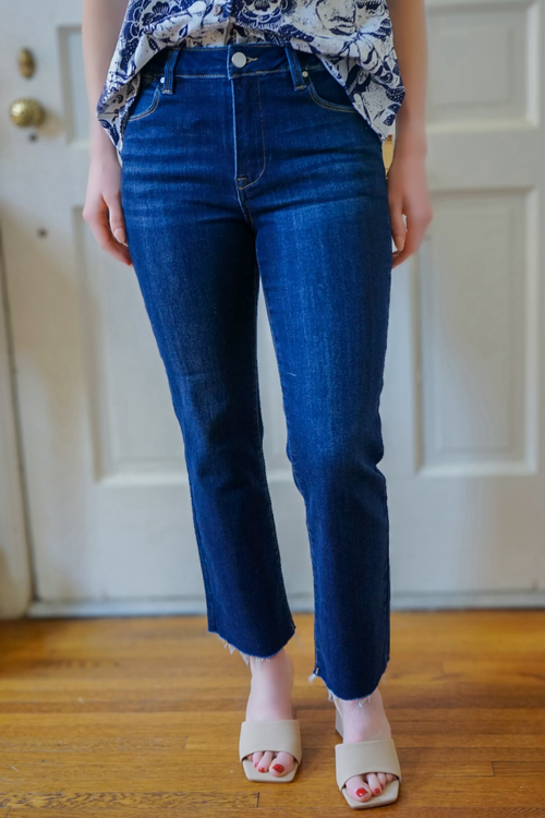 Model is wearing Risen brand dark denim jeans with straight leg design