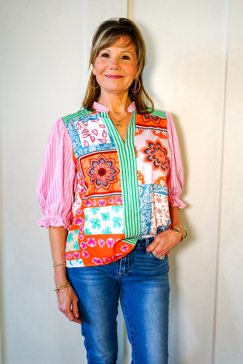 Model is wearing a mixed media blouse by THML with a patchwork design in pinks, greens, blues, and creams