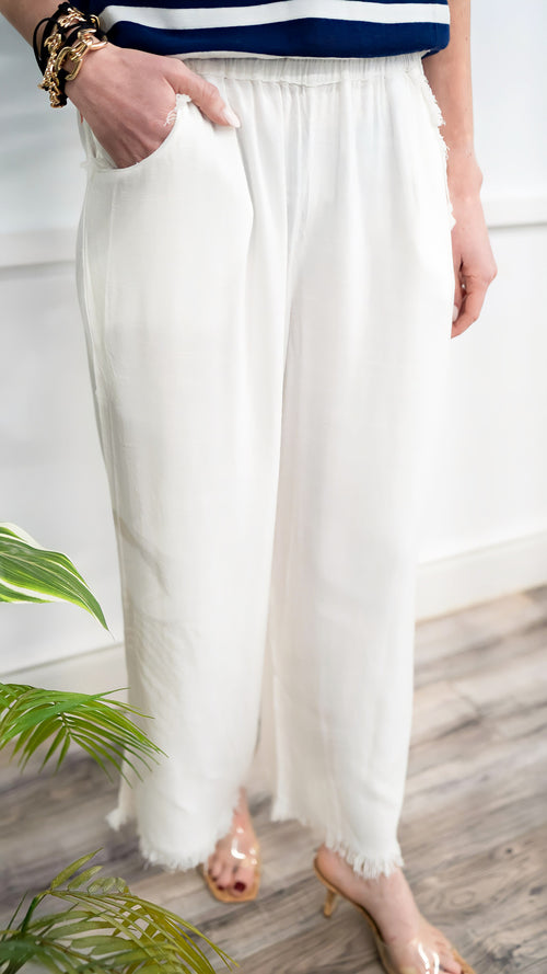 Model is wearing white, casual, pull on gauze pants.