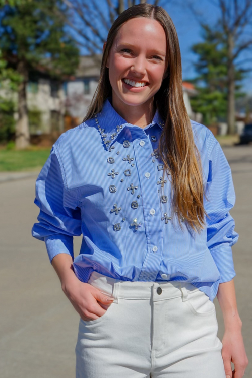 Model is wearing a blue and white striped poplin button down embellished with rhinestones