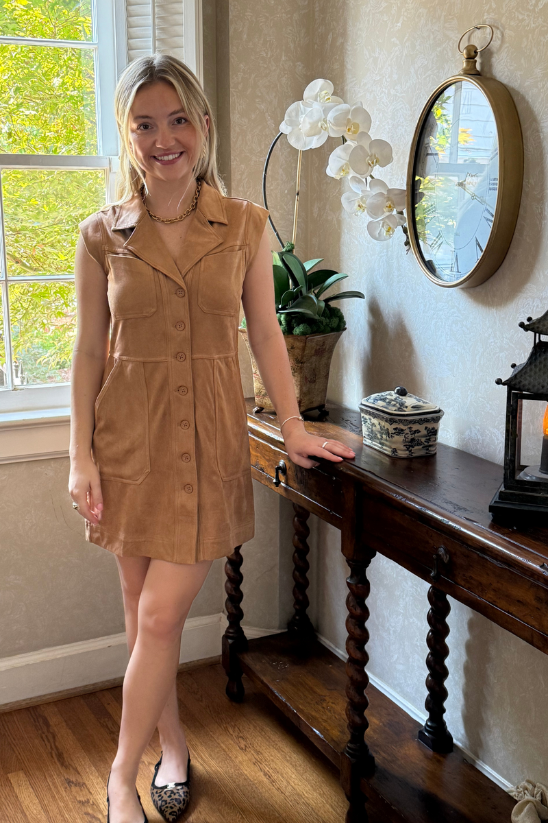 Model is wearing a camel suede-look shirt-style sleeveless dress.