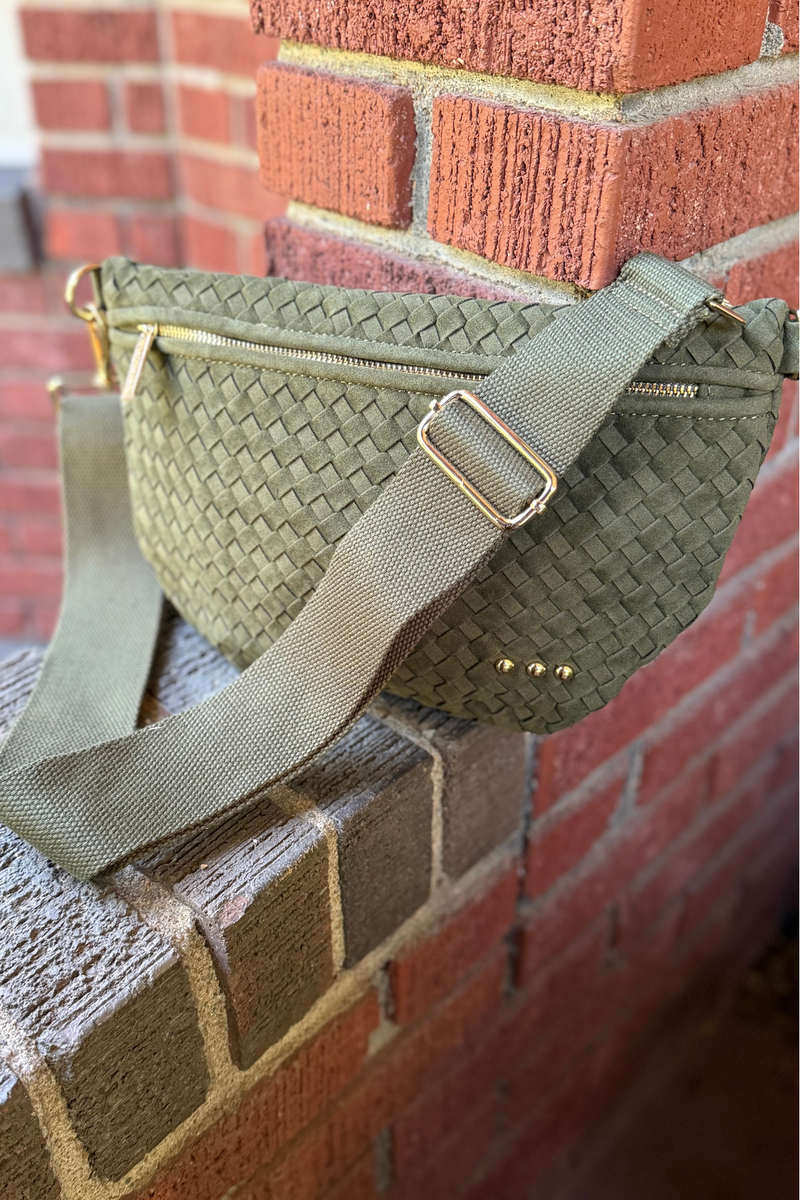 Bag is olive suede-feel woven cross body