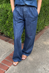Model is wearing a dark wash denim pull-on style pant.