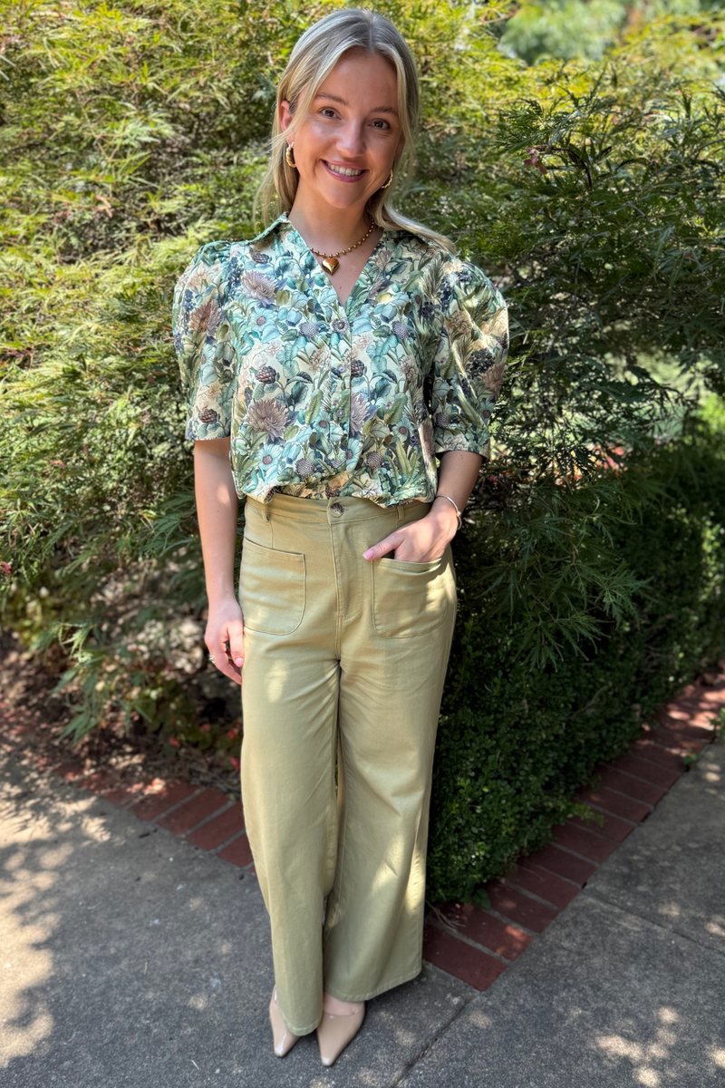 Model is wearing sage twill pants with front patch pockets