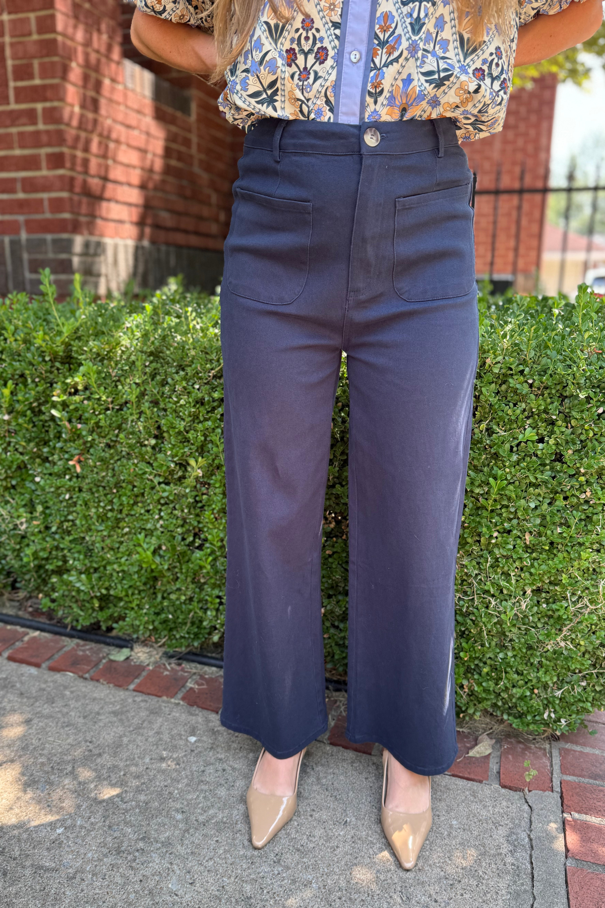 Model is wearing a navy twill pant with front patch pockets.