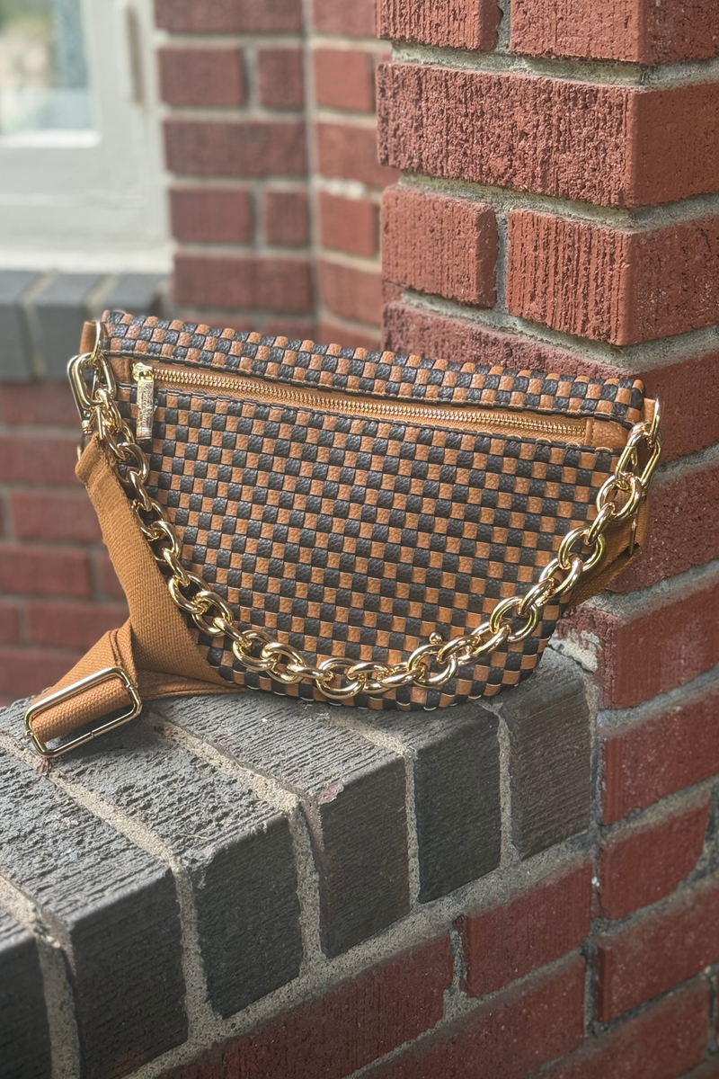 Photo features a coffee and black checkered pattern faux leather pattern. Bag is featured with an option gold metal chain strap. 