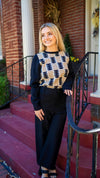 Model is wearing a THML midweight black sweater with black, camel and cream geometric print throughout the bodice