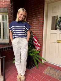 Model is wearing a navy and white striped short sleeve sweater