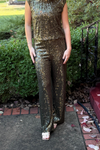 model is wearing olive green sequin pants